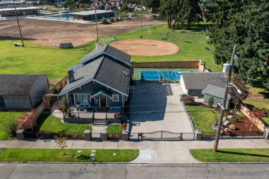 Composite deck with a covered outdoor kitchen on a multi-generation Fircrest lot