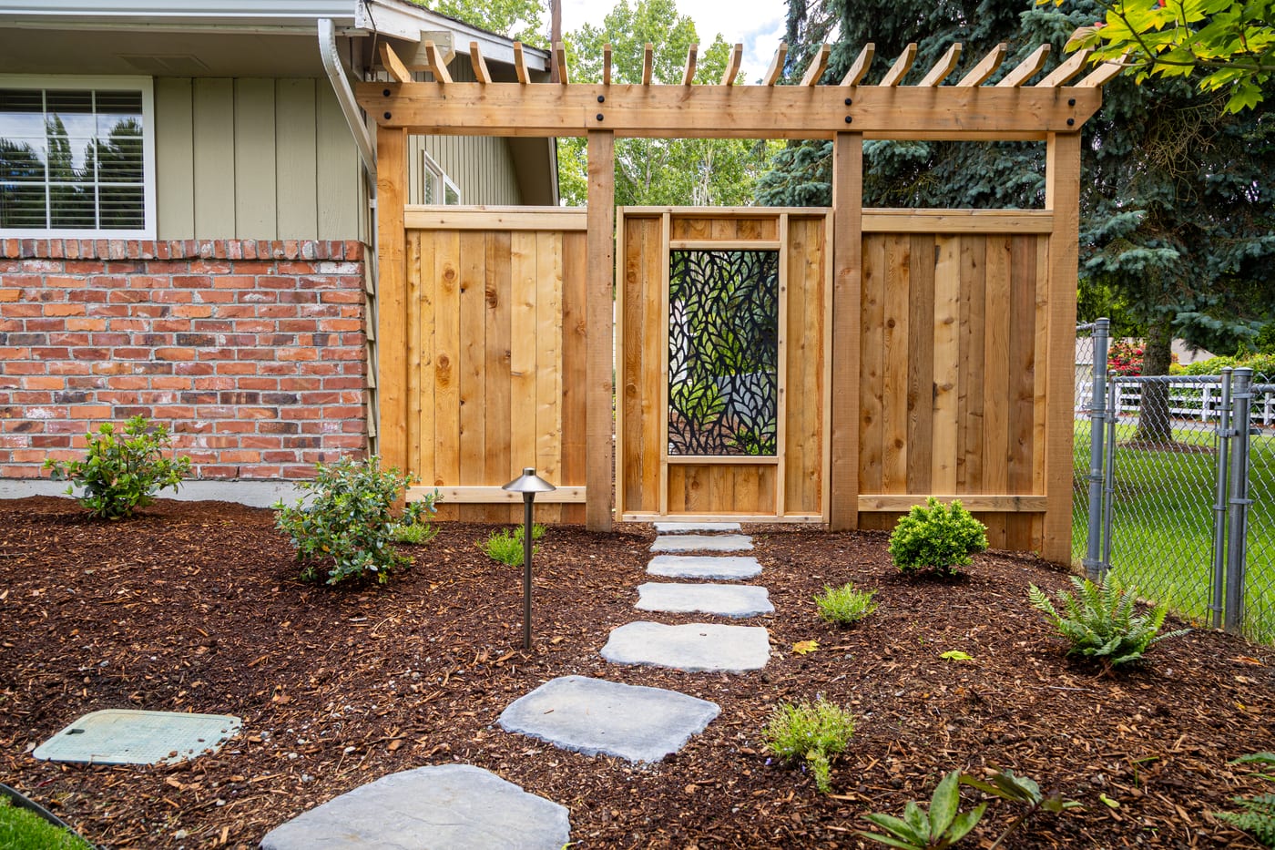 Custom cedar arbor and gate with a Veradek privacy screen on the side yard