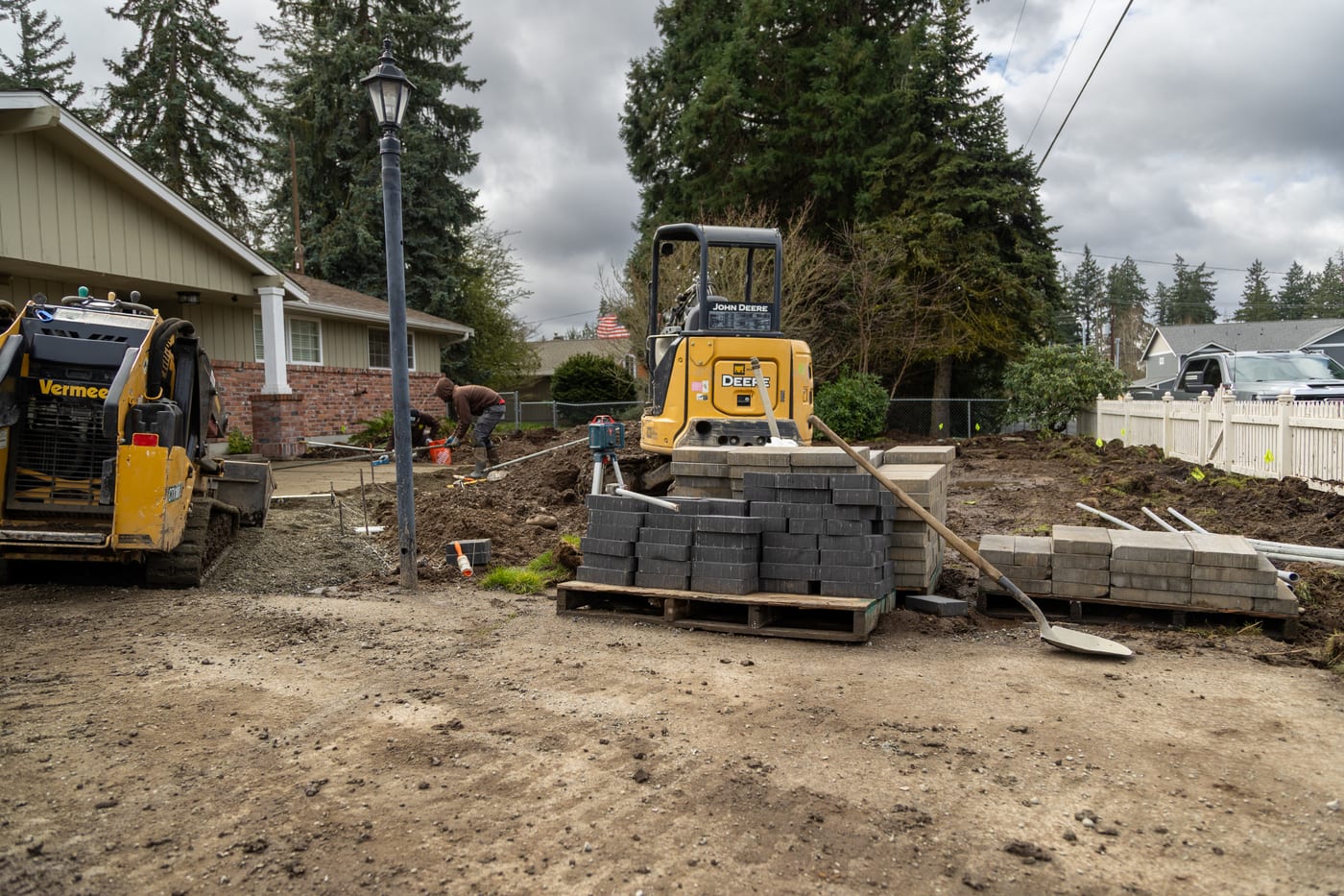 An excavator grading the front yard during construction