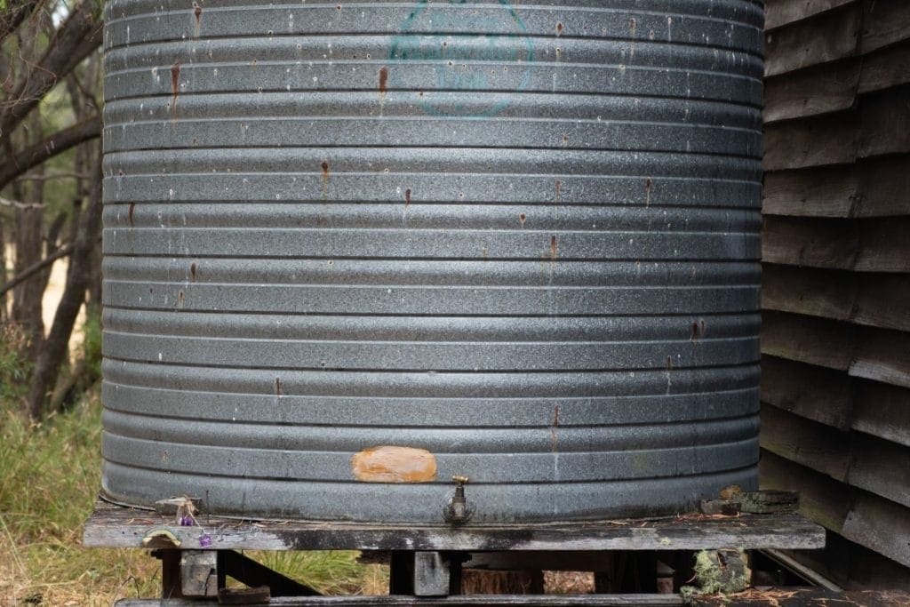 a rain barrel part of DIY Rainwater Collection Systems